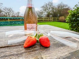 A bottle of champagne and glasses with strawberries at The Beach Retreat in The Bay - Filey