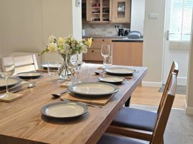 A dining room with a table set for a meal at Bay Tree Cottage in Keswick