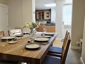 A dining room with a table set for a meal at Bay Tree Cottage in Keswick