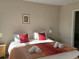 A bedroom with a bed and bedside table at Bay Tree Cottage in Keswick