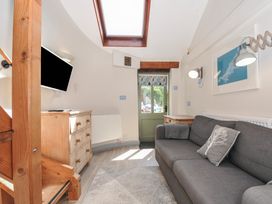 A living room with a sofa and television at Little Coombe Trehunist near Liskeard