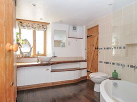 A bathroom with a sink, toilet and bath at Little Coombe Trehunist near Liskeard
