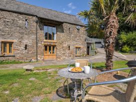 An outdoor seating area with a table and croissants at Little Coombe Trehunist near Liskeard