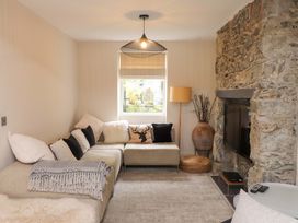 A living room with a sofa and television at Hendre in Menai Bridge