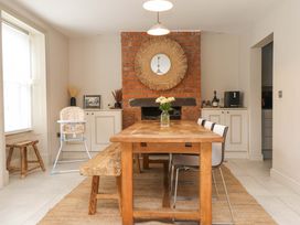 A dining room with a wooden table and chairs at Hendre in Menai Bridge