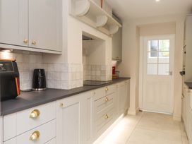 A kitchen with cabinets and appliances at Hendre in Menai Bridge
