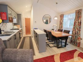 A dining room with a table and chairs at Merewood in Troutbeck Bridge