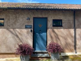 A blue door with a sign at Church Farm Dairy Cadbury near Thorverton