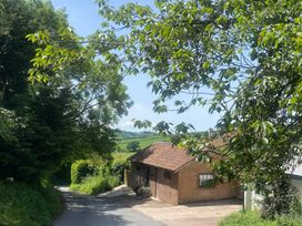 A view of a road with a house and trees at Church Farm Dairy Cadbury near Thorverton