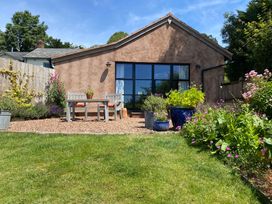 A house with a garden and seating area at Church Farm Dairy Cadbury near Thorverton