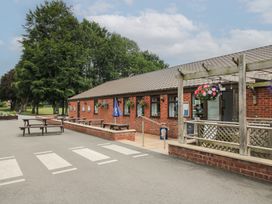 An outdoor seating area with tables and flowers at Swan in Shobdon