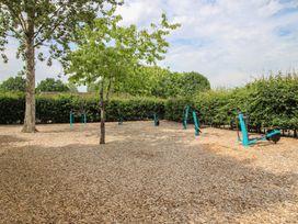 An outdoor exercise area with equipment and wood chips at Swan in Shobdon