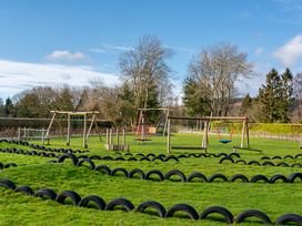 A playground with swings and tires at Heron in Shobdon