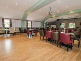 A dining room with tables and chairs at Owl in Shobdon