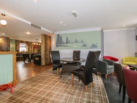 A lounge with a dining table and dartboard at Owl in Shobdon