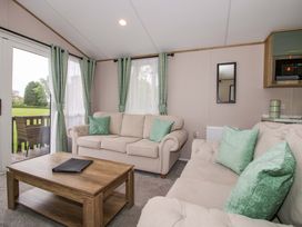 A living room with a sofa and coffee table at Owl in Shobdon