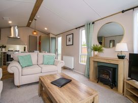 A living room with a sofa and coffee table at Owl in Shobdon