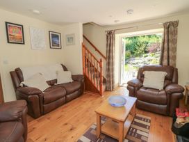 A living room with a sofa and coffee table at Felin Gogoyan in Tregaron