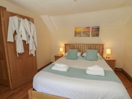 A bedroom with a bed and bedside table at Felin Gogoyan in Tregaron