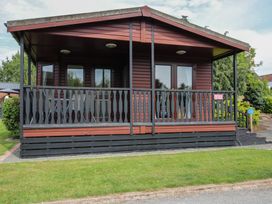 A house with a deck and windows at Snowdrop in Eardisland