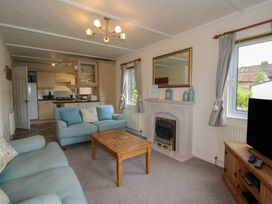 A living room with a sofa and coffee table at Snowdrop in Eardisland