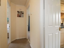 A hallway with a painting and doors at Snowdrop in Eardisland