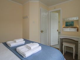 A bedroom with towels on a bed at Snowdrop in Eardisland