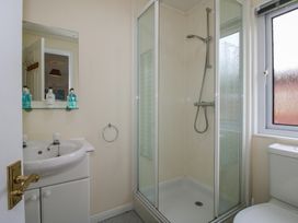 A bathroom with a sink, shower, and toilet at Snowdrop in Eardisland