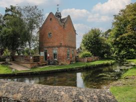 A building near a canal with a shop sign and bicycles at Snowdrop in Eardisland