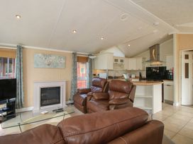 A living room with a fireplace and sofa at Daisy in Eardisland
