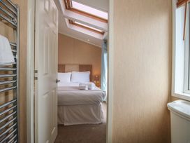 A bedroom with a bed and towels at Daisy in Eardisland