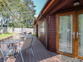 A deck area with a table and chairs at Foxglove in Eardisland