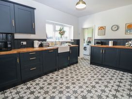 A kitchen with cabinets and sink at Sunrise House near Pakefield