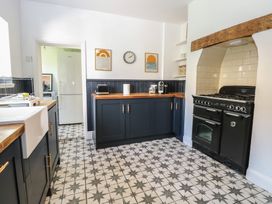 A kitchen with cabinets and an oven at Sunrise House in Pakefield near Lowestoft