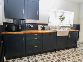 A kitchen with cabinets and appliances at Sunrise House in Pakefield near Lowestoft