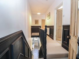 A hallway with staircase and doors at Sunrise House Pakefield near Lowestoft