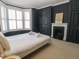 A bedroom with a bed and towels at Sunrise House Pakefield near Lowestoft