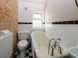 A bathroom with a bathtub and toilet at Sunrise House Pakefield near Lowestoft
