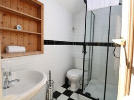 A bathroom with a sink, toilet, and shower at Sunrise House in Pakefield near Lowestoft