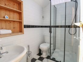A bathroom with a shower, toilet, and sink at Sunrise House Pakefield near Lowestoft