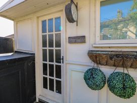 An outdoor entrance with a clock and plants at Sunrise House Pakefield near Lowestoft