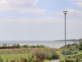 A view of the sea with a lamp post and flowers at Sunrise House in Pakefield near Lowestoft