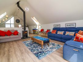 A living room with a wood stove and seating area at Pebble Ridge View in Westward Ho!