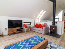A living room with a television and sofa at Pebble Ridge View in Westward Ho!
