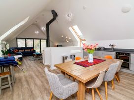 A living room with a dining table and sofa at Pebble Ridge View in Westward Ho!