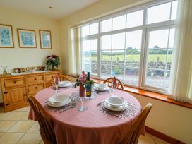 A dining room with a table set for dinner at The Cottage at Ty Newydd in Brynsiencyn