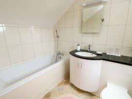 A bathroom with a bathtub and sink at The Cottage at Ty Newydd in Brynsiencyn