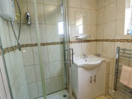 A bathroom with a shower and sink at The Cottage at Ty Newydd in Brynsiencyn