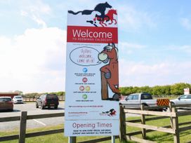A welcome sign for Redwings Caldecott horse sanctuary in a parking area at Hazell Thorne Hideaway in Fritton
