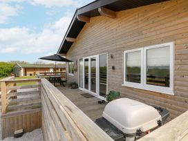 An outdoor area with a table and grill at Monks Rest in Monknash
